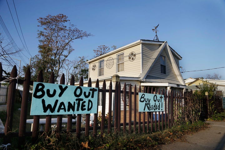 Signs asking for a "buy out" hang in front of a home damaged by Hurricaine Sandy on Staten Island, New York.