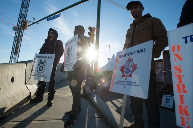 Striking CN rail members are seen outside the McLean Rail Yard in North Vancouver on