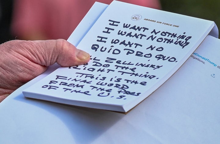 President Donald Trump holds what appears to be a prepared statement and handwritten notes after watching testimony by U.S. Ambassador to the European Union Gordon Sondland.