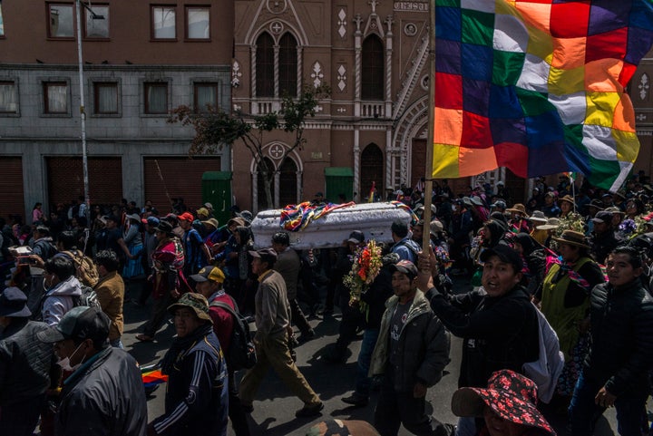 Supporters of the resigned Bolivian head of state Morales march in La Paz, the capital, carrying a coffin with the remains of a victim killed in the recent violent clashes and demanding the end of the current interim government.