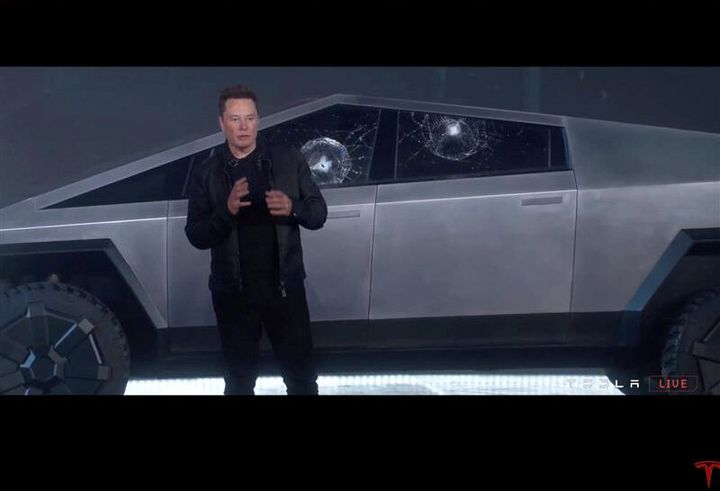 Tesla chief executive Elon Musk stands in front the company's first electric pickup truck, the Cybertruck, in Los Angeles on Thursday after windows were smashed with a metal ball. 