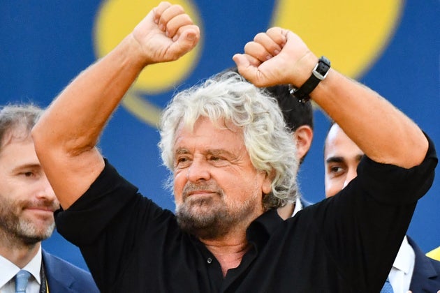 Founder of the Five Star Movement (M5S), Italian comedian and political activist Beppe Grillo (C) gestures as M5S prominent figure, Italian entrepreneur and political activist Davide Casaleggio (L) and Head of M5S, Italys Labor and Industry Minister and deputy PM Luigi Di Maio (Rear R) look on at the end of a convention of the governing coalition's populist movement on October 21, 2018 in Rome. (Photo by Alberto PIZZOLI / AFP) (Photo credit should read ALBERTO PIZZOLI/AFP via Getty Images)