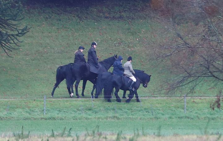 Prince Andrew (second from left) rides a horse on the grounds of Windsor Castle, alongside the queen on Friday.