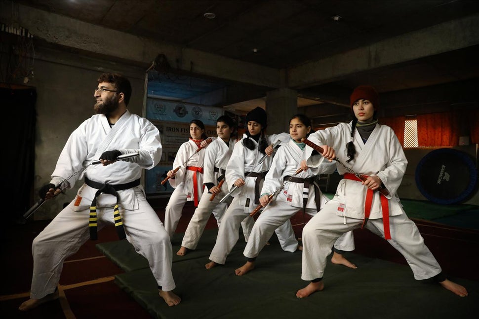 Peerzada Adil Iqbal Shah leading girl students during a training session at his martial arts academy in Soura, Srinagar. 