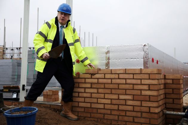 Johnson lays a brick during a Conservative Party general election campaign visit to Barratt Homes's 'Willow Grove' residential housing development in Bedford, east England.