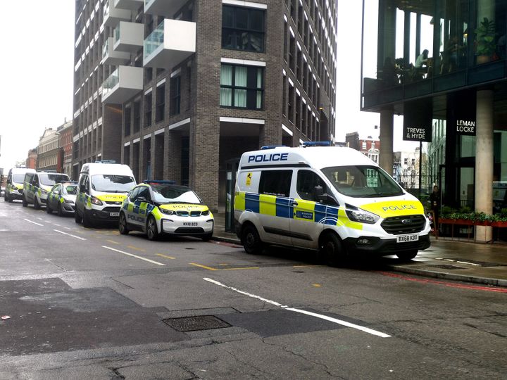 Police at the scene on Buckle Street, Whitechapel, east London, after a man died and another three were injured following a stabbing. 