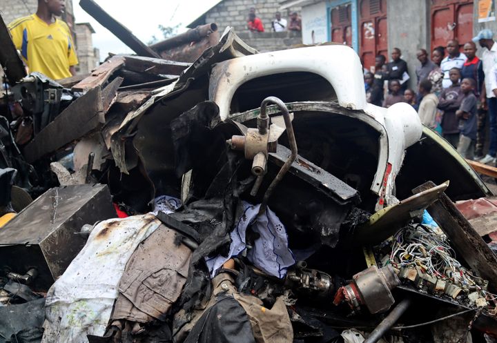 Civilians gather at the site where a Dornier 228-200 plane operated by local company Busy Bee crashed into a densely-populated neighborhood in Goma, eastern Democratic Republic of Congo.