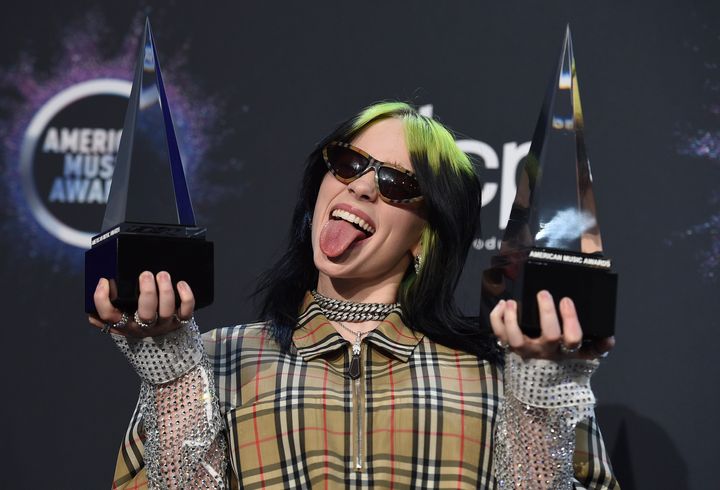 Billie Eilish poses in the press room with the award for new artist of the year and favourite alternative rock artist at the American Music Awards