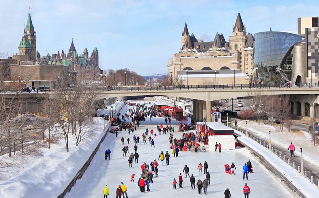In this stock photo, skaters are seen on the Rideau Canal in downtown Ottawa, with Parliament Hill on...