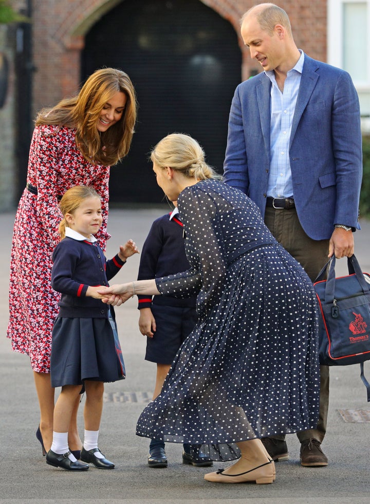 Helen Haslem, head of the lower school, greets Princess Charlotte as she arrives for her first day of school, with her brother Prince George and her parents the Duke and Duchess of Cambridge, at Thomas's Battersea in London on Sept. 5, 2019.