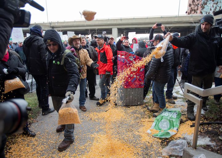 Farmers dump bags of corn grain in front of the office of Justin Trudeau, as they protest the lack of propane due to the CN Rail strike in Montreal on Nov. 25, 2019. 