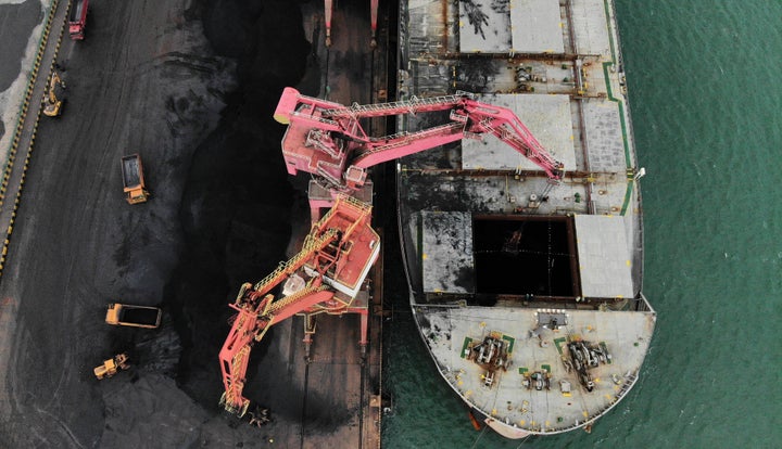 Aerial photo taken on Nov. 21, 2019 shows a cargo ship being loaded up with coal at Rizhao Port in China.