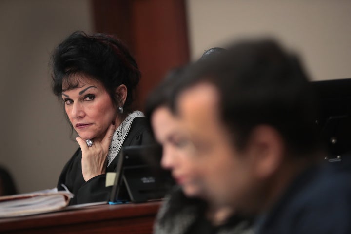 Judge Rosemarie Aquilina (L) looks at Larry Nassar (R) as he listens to a victim's impact statement.