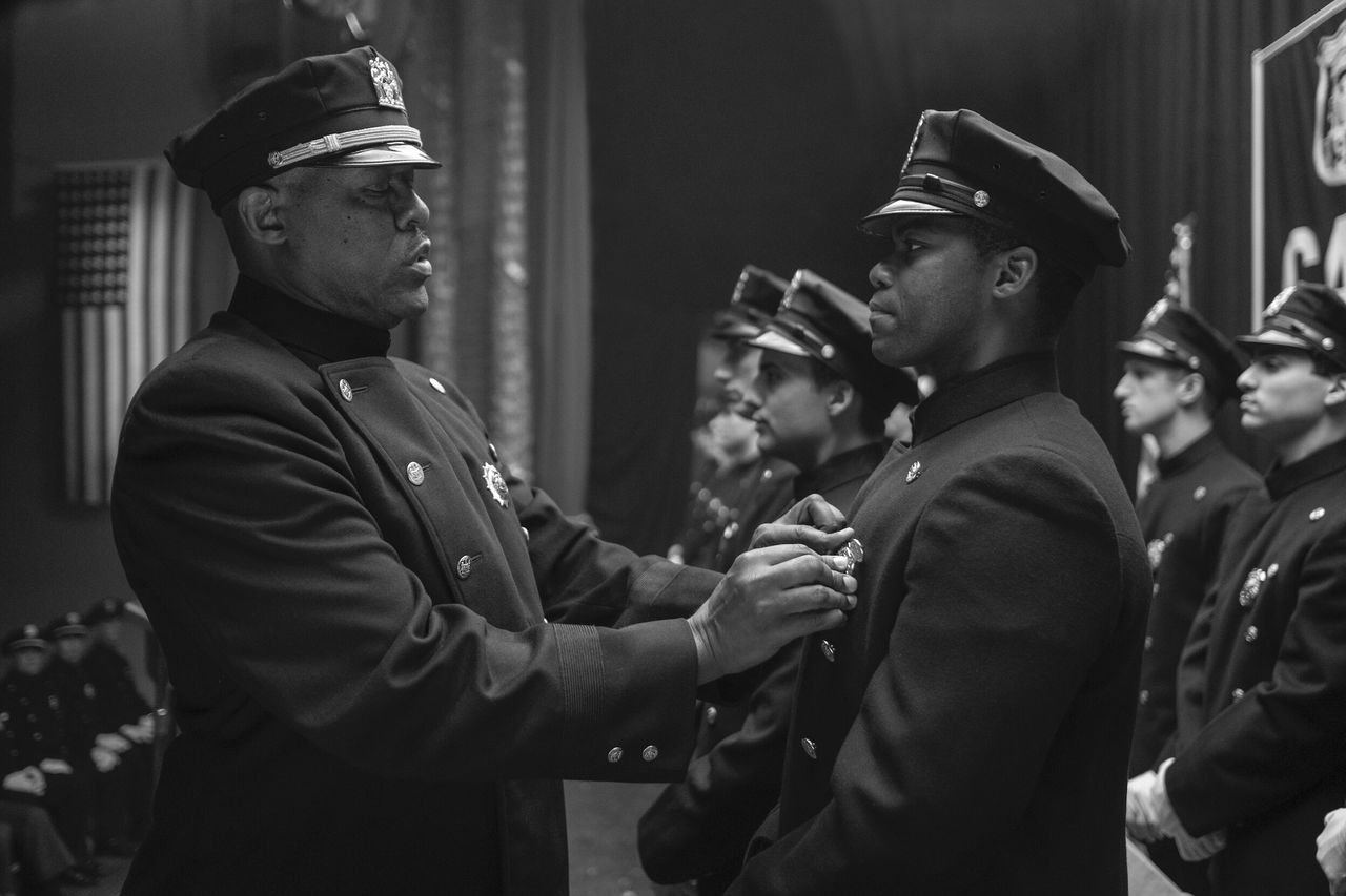 Will Reeves, right, portrayed by Jovan Adepo, is inducted into the New York Police Department.