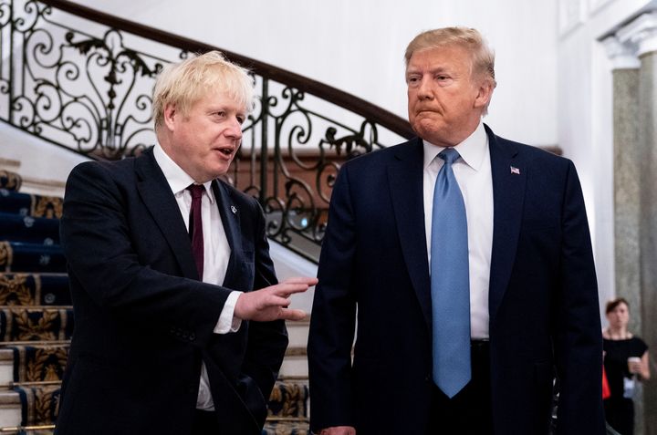 President Donald Trump and Britain's Prime Minister Boris Johnson, left, speak to the media before a working breakfast meeting at the Hotel du Palais on the sidelines of the G-7 summit in Biarritz, France, Sunday, Aug. 25, 2019.