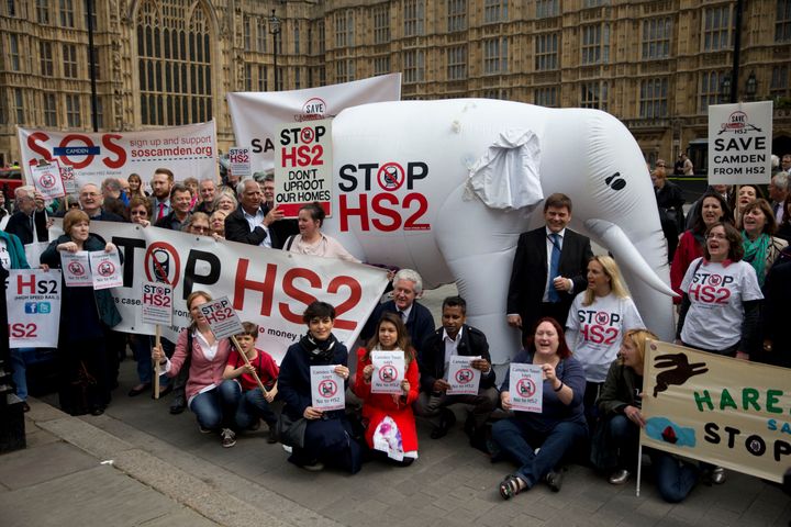 Campaigners against the construction of the proposed HS2 (High Speed 2) railway line pose for a group photograph for the media with banners and an inflatable white elephant in 2014.