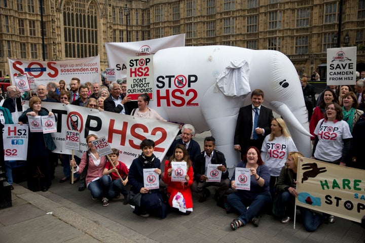 <strong>Campaigners against the construction of the proposed HS2 (High Speed 2) railway line pose for a group photograph for the media with banners and an inflatable white elephant in 2014.</strong>