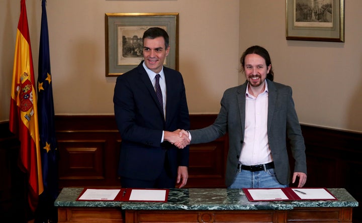 Spanish Prime Minister Pedro Sánchez and Unidas Podemos leader Pablo Iglesias shake hands during a news conference on Nov. 12. 