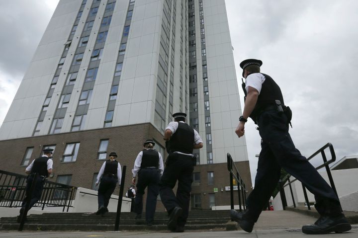 Police officers outside Dorney Tower, part of the Chalcots Estate, during the start of the evacuation