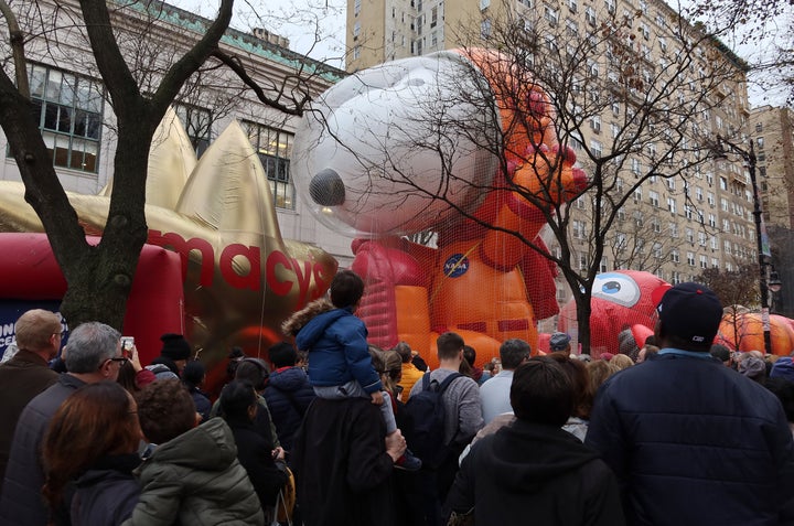 People walk past the Astronaut Snoopy balloon after it was inflated for the annual Macy's Thanksgiving Day Parade in New York.