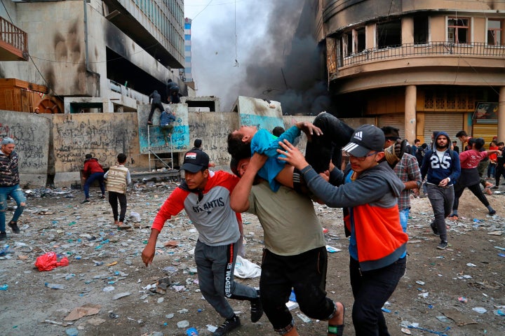 A wounded protester is carried to receive first aid during clashes with security forces on Rasheed Street in Baghdad, Iraq, on Nov. 28, 2019. 