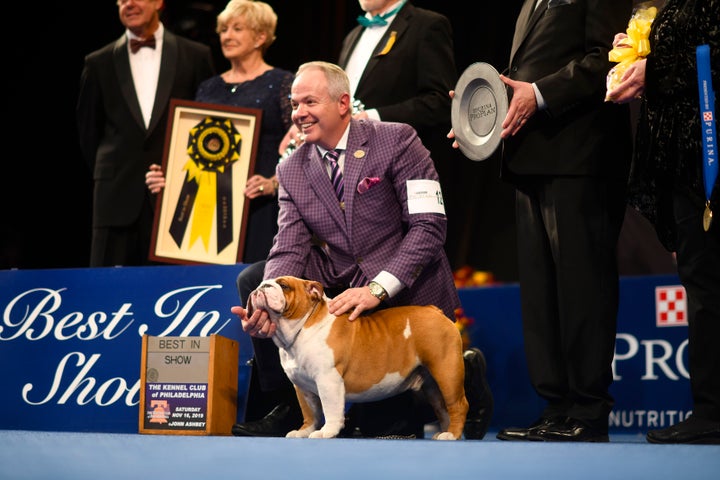 Eduardo Paris, a native of Peru, poses for a group photo as Thor wins the Best in Show on Thursday at the Greater Philadelphia Expo Center.