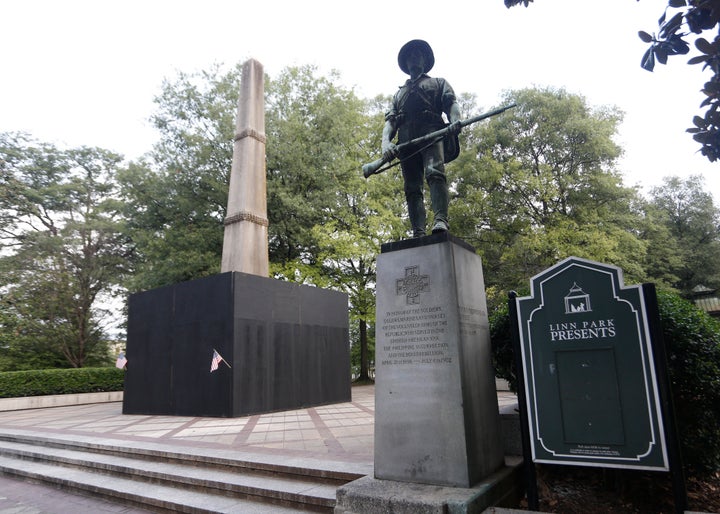 Inscriptions on an obelisk in Birmingham, Alabama, honoring Confederate soldiers is covered in plywood in 2017.