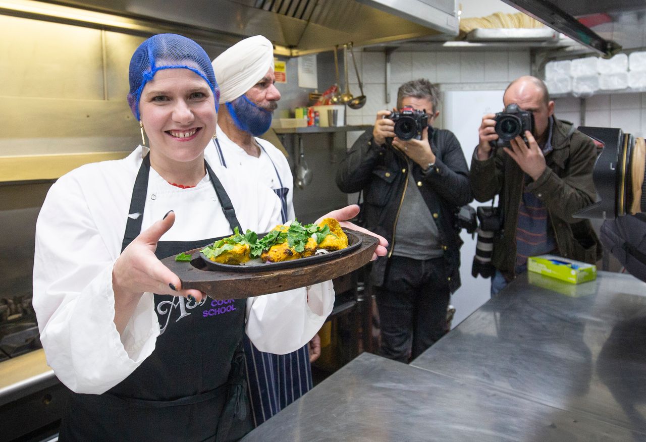 Liberal Democrat leader Jo Swinson helps make a chicken tikka masala during a visit to the Ashoka restaurant in Bearsden, Glasgow, during the general election campaign.