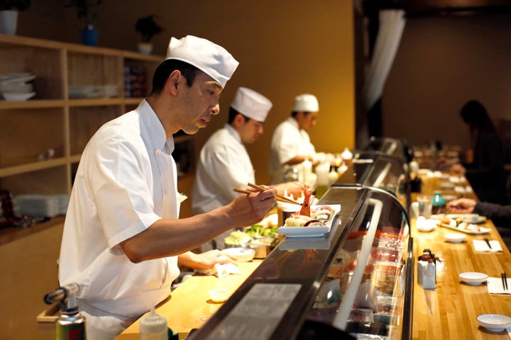 Sushi chef Hiro Ishii of Benkay in Portland, Maine, puts the final touches on omakase, a sushi platter that roughly translates to chef's choice.