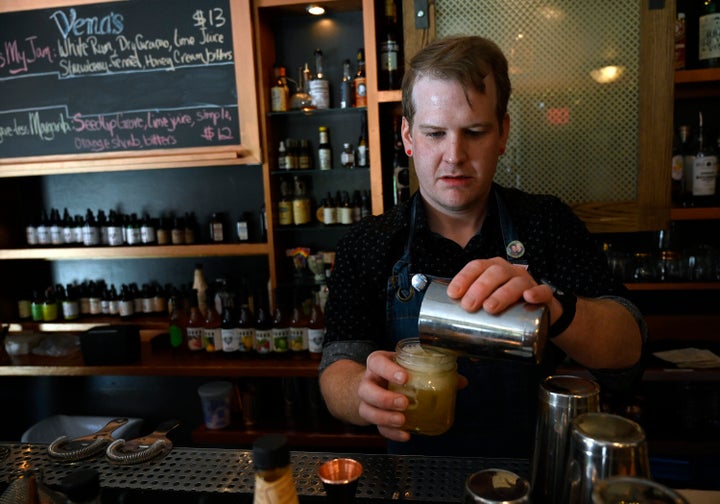 Bartender Dan Purcell mixes up a pineapple-rosemary shrub mocktail at Vena's Fizz House in Portland, Maine.