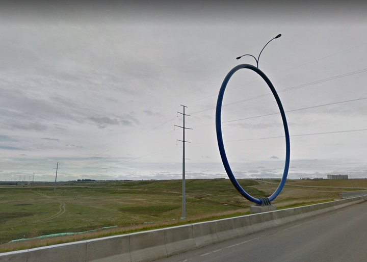 Travelling Light, also known as the giant blue ring, sits on the edge of a Calgary highway.