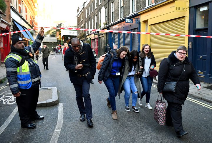 People being allowed to pass a cordon near Borough Market in the wake of the incident on Friday afternoon. 
