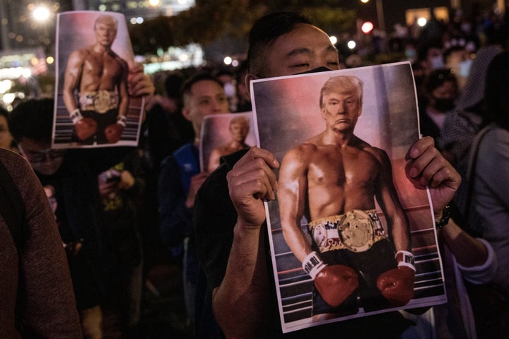 Pro-democracy protesters hold posters of President Donald Trump (as Rocky Balboa) during a rally at Edinburgh Place on Nov. 28 in Hong Kong.