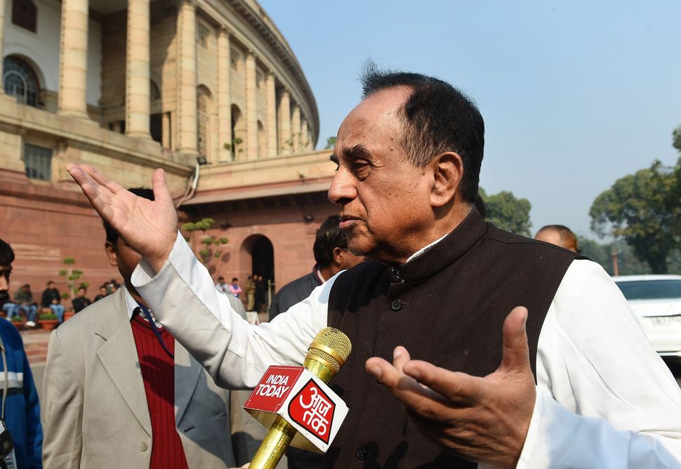 BJP leader Subramaniam Swamy interacts with members of the media at Parliament House in New Delhi on December 17, 2015. 