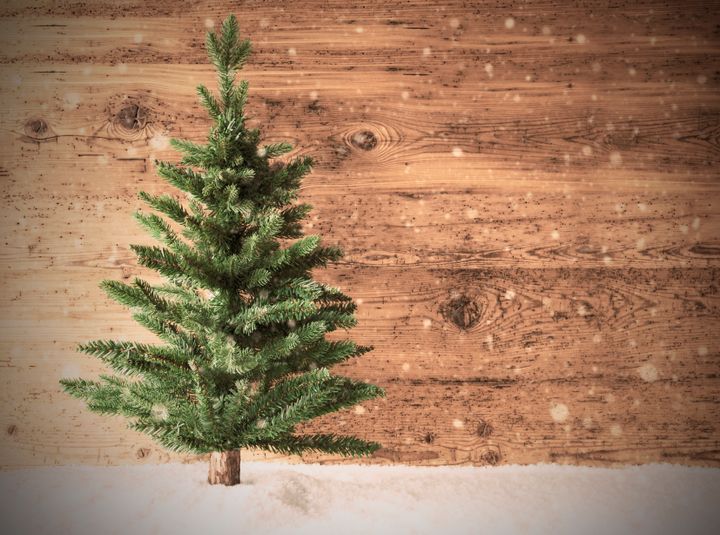 Retro Christmas Tree On Brown Wooden Background With Snow. Copy Space For Advertisement.