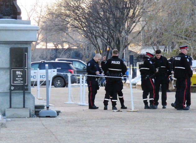 Police stand outside of the Alberta Legislature after being called for a weapons complaint related to a body on the front steps of building on Dec. 2, 2019.