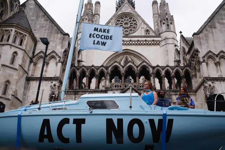 Climate change activist group Extinction Rebellion demonstrates outside the Royal Courts of Justice in London in July 2019 wi