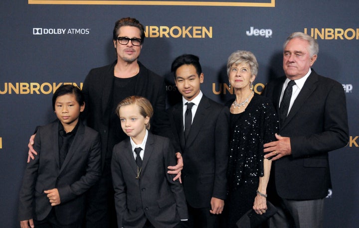 Brad Pitt arrives at the premiere of "Unbroken" with children Pax, Shiloh, Maddox and parents Jane Pitt and William Pitt in 2014. 