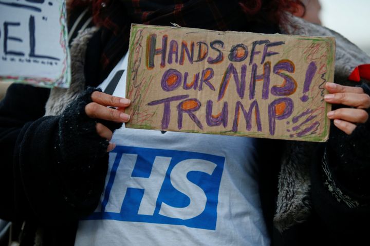 A protester at a 'Hands Off Our NHS' rally in central London, where Donald Trump is set to visit Buckingham Palace 