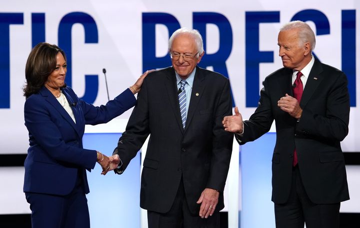 Kamala Harris greets Bernie Sanders and Joe Biden before the start of the U.S. Democratic presidential candidates 2020 election debate in Ohio U.S. on Oct. 15, 2019. 