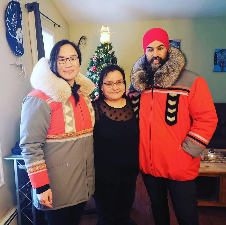 Marlene Watson, centre, stands with Jagmeet Singh and Mumilaaq Qaqqaq as they wear her handmade parkas.