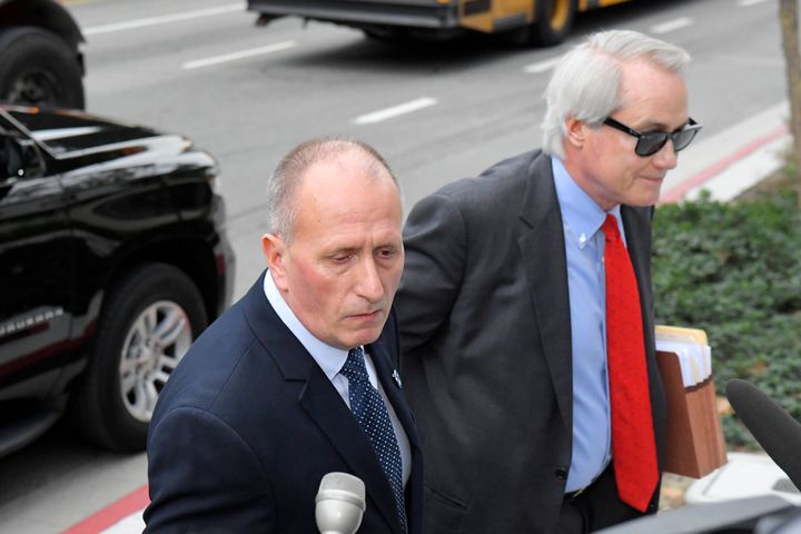 L. Lin Wood, right, attorney for plaintiff, British cave expert Vernon Unsworth, left, arrives for the trial against Tesla CEO Elon Musk at U.S. District Court Tuesday, Dec. 3, 2019, in Los Angeles. Musk is going on trial for his troublesome tweets in a case pitting the billionaire against a British diver he allegedly dubbed a pedophile. (AP Photo/Mark J. Terrill)