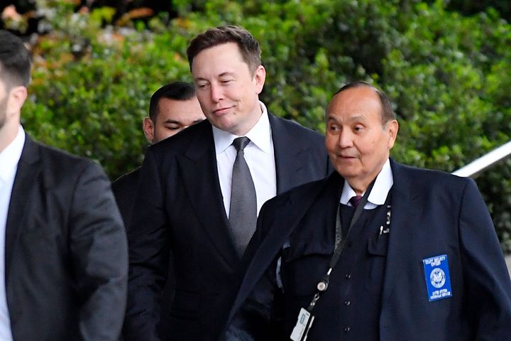 Tesla CEO Elon Musk, second from right, arrives at US District Court Wednesday, Dec 4, 2019, in Los Angeles