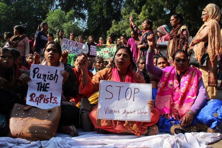 Protestors holds a placard and shout slogans during a sit-in protest as Delhi Commission for Women (DCW) chief Swati Maliwal launched an indefinite hunger strike against the Hyderabad rape-murder case and growing incidents of crime against women, in the presence of other protesters, at Jantar Mantar, on December 3, 2019 in New Delhi.