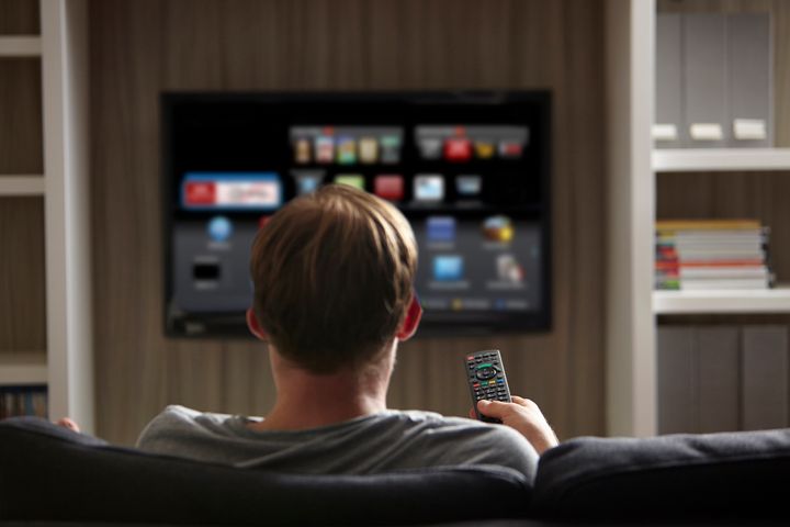 A man watches television on a smart TV in this undated stock photo. The FBI says it's important to know your TV's capabilities before buying one. 
