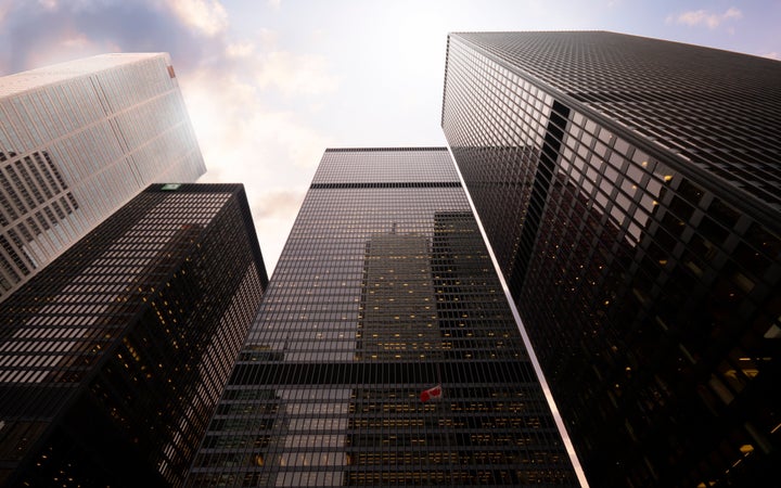 This stock photo shows the headquarters of some of the big Canadian banks in Toronto's financial district. Canada's big banks are setting aside much more money than before to cover loan losses.