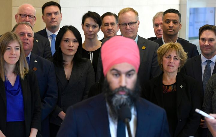 Caucus members watch as NDP leader Jagmeet Singh speaks to reporters after the weekly caucus meeting in Ottawa on Dec. 4, 2019. 