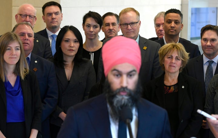 Caucus members watch as NDP leader Jagmeet Singh speaks to reporters after the weekly caucus meeting in Ottawa on Dec. 4, 2019.