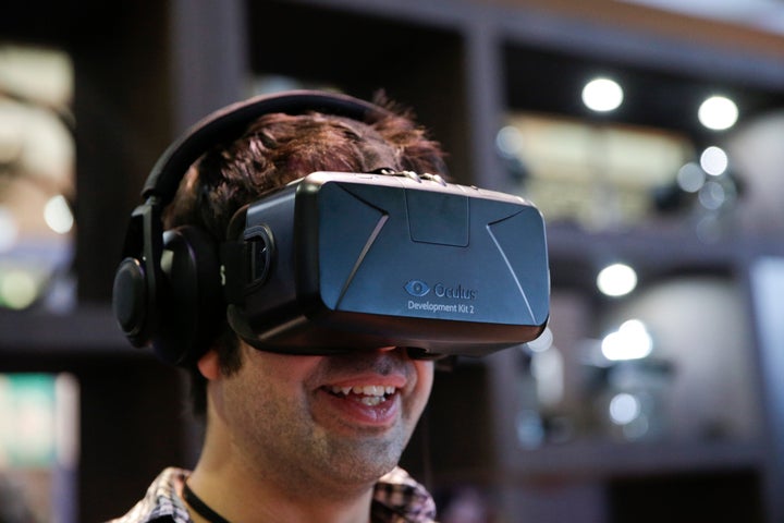 A man tries out the Oculus Rift virtual reality headset at the Oculus booth at the Electronic Entertainment Expo on Wednesday, June 11, 2014.