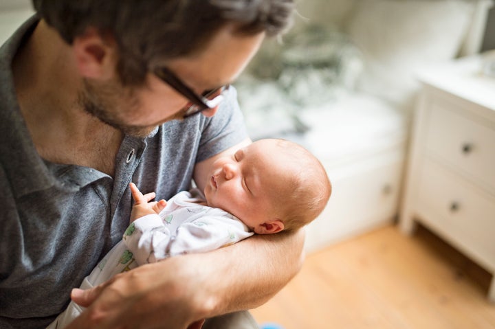 Father at home with his baby daughter